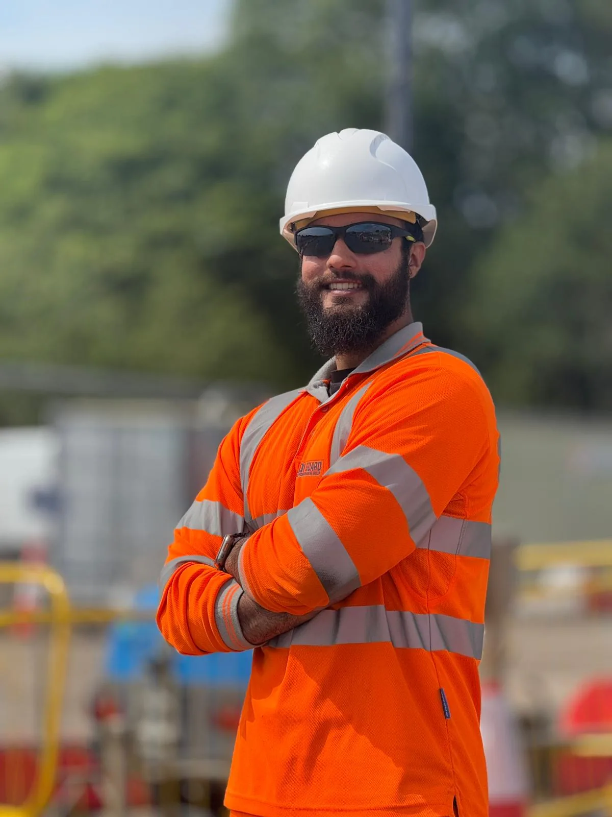 Professional security officer in high-visibility workwear at a construction site